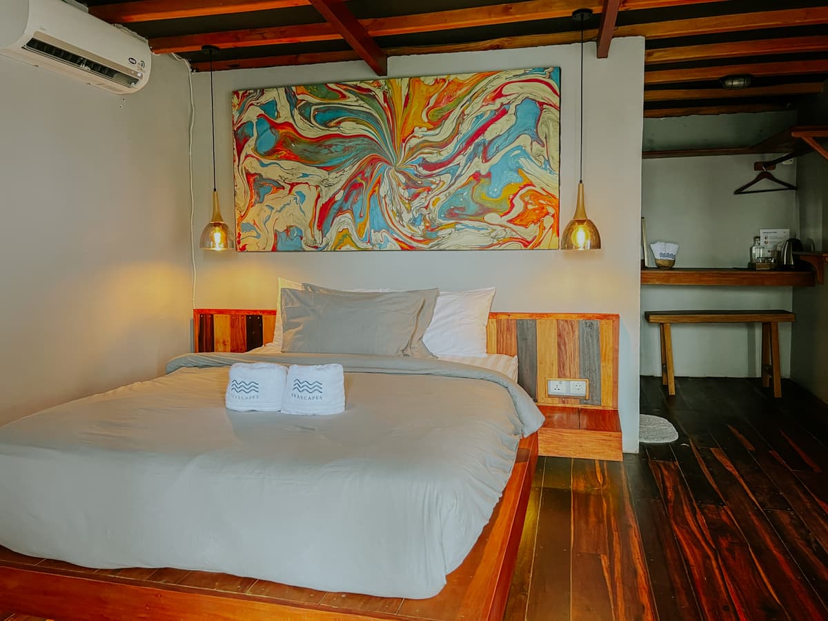 Borneo bedroom with a marbled painting above the bed